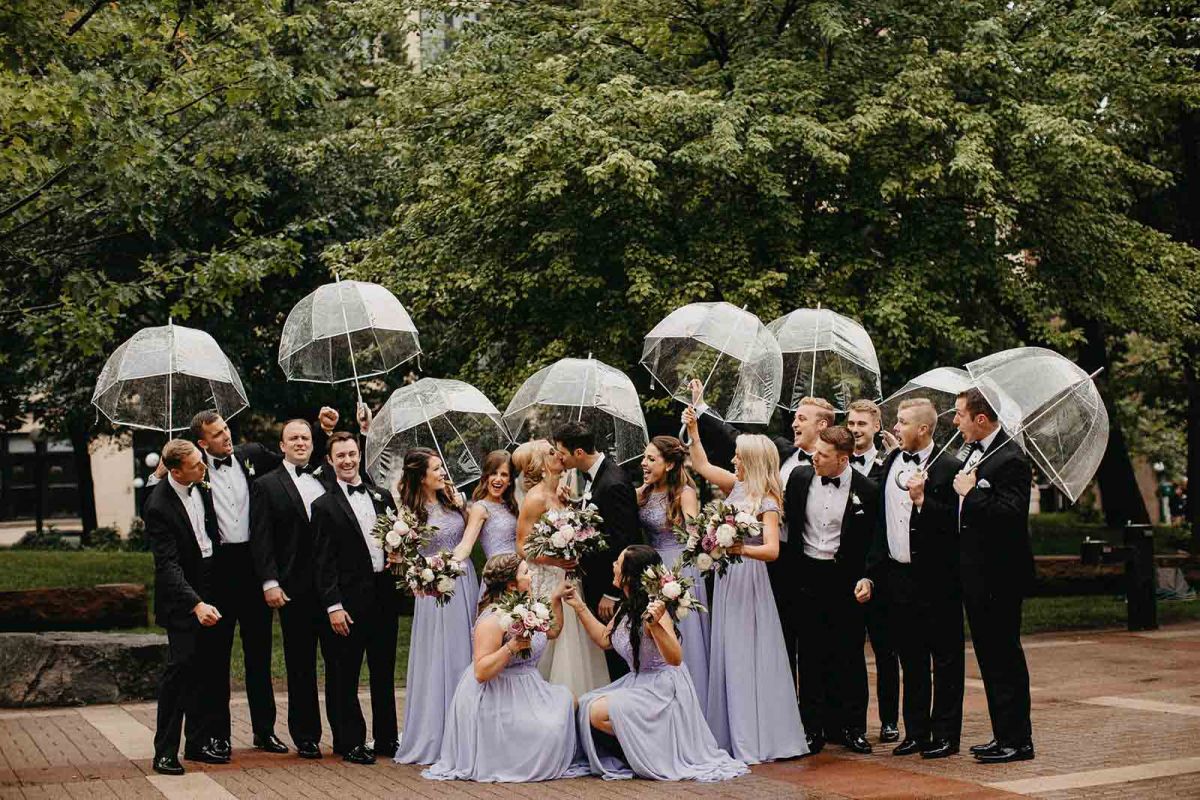 wedding party with umbrellas posing