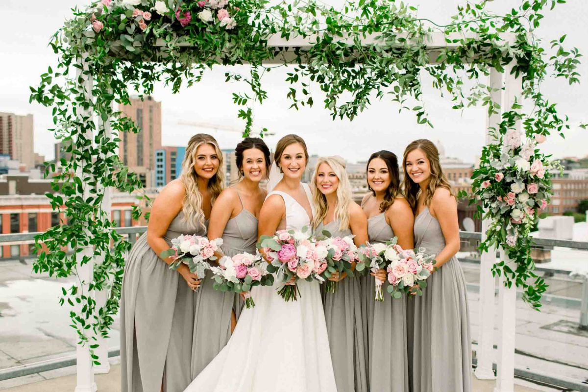 wedding party posing on rooftop