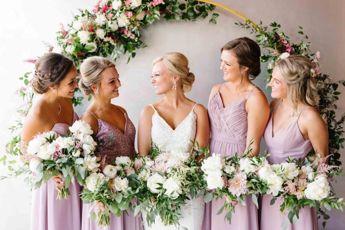 bridesmaids smiling at bride