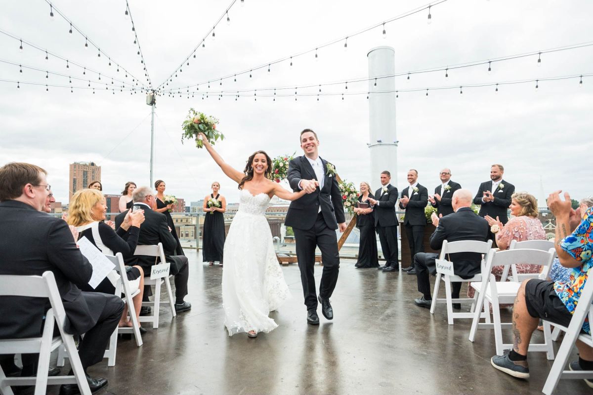 couple celebrating down aisle