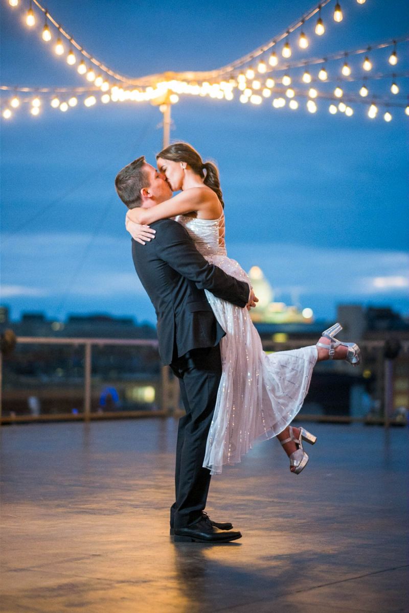 Couple posing at nightime on the rooftop at A'BULAE