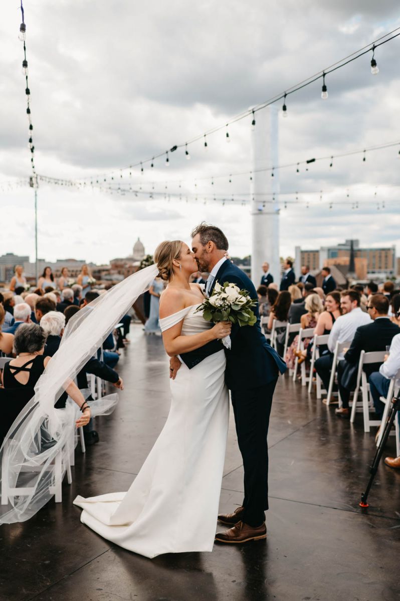 couple kissing in aisle