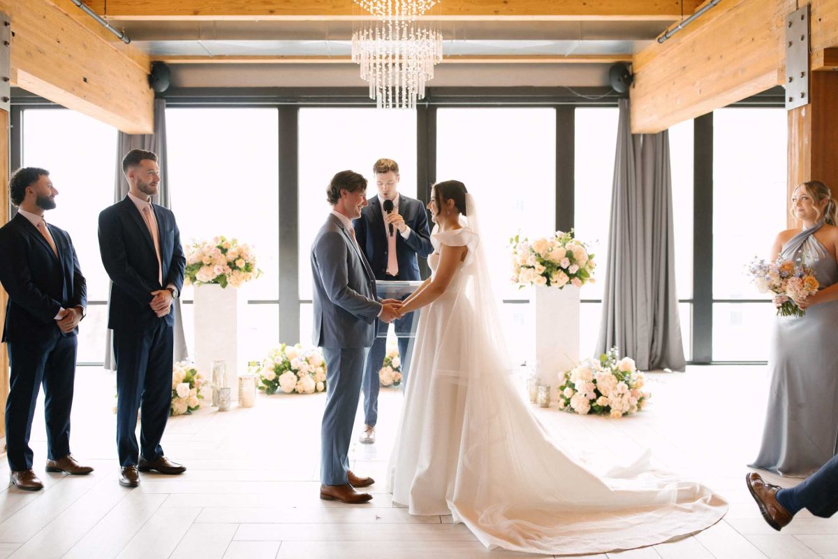 couple holding hands at altar