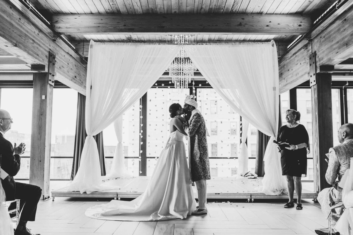 couple kissing at altar
