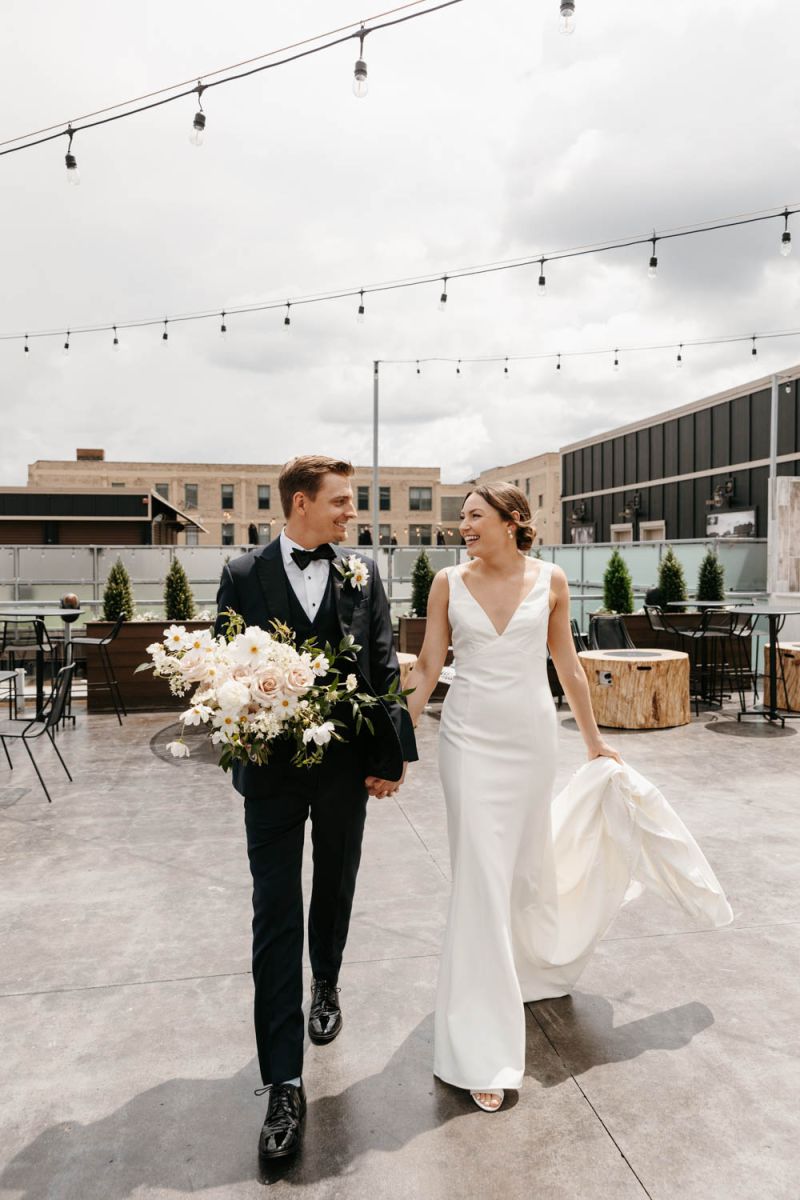 couple walking on rooftop holding hands