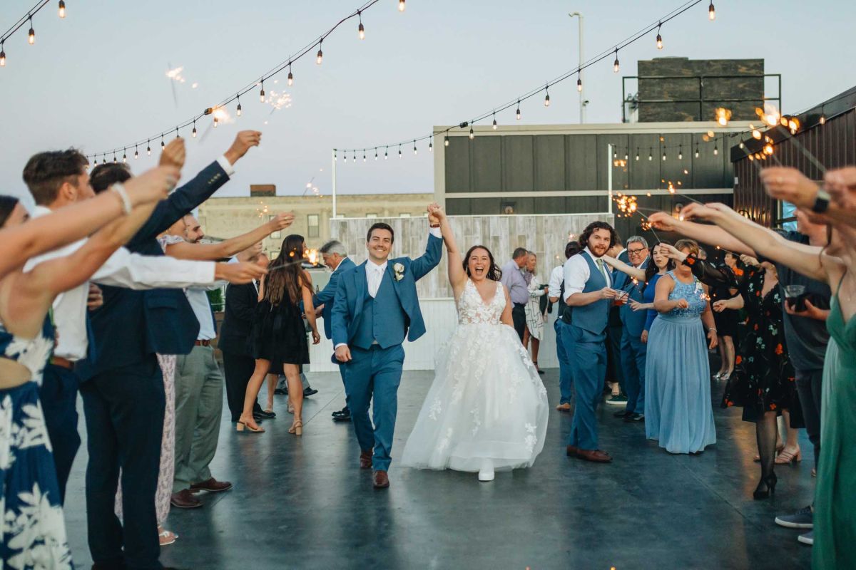 couple walking through sparkler exit