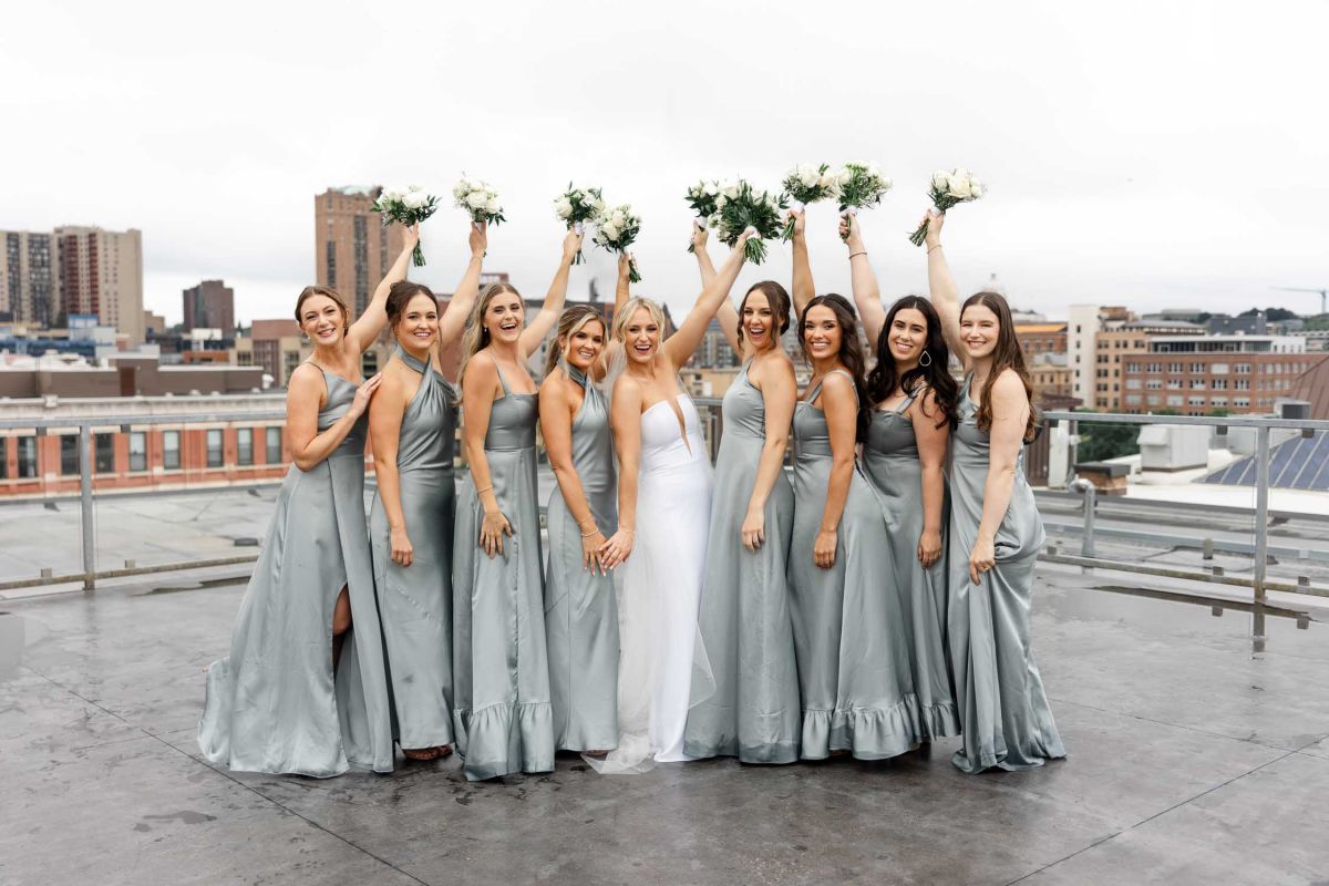 wedding party posing on rooftop