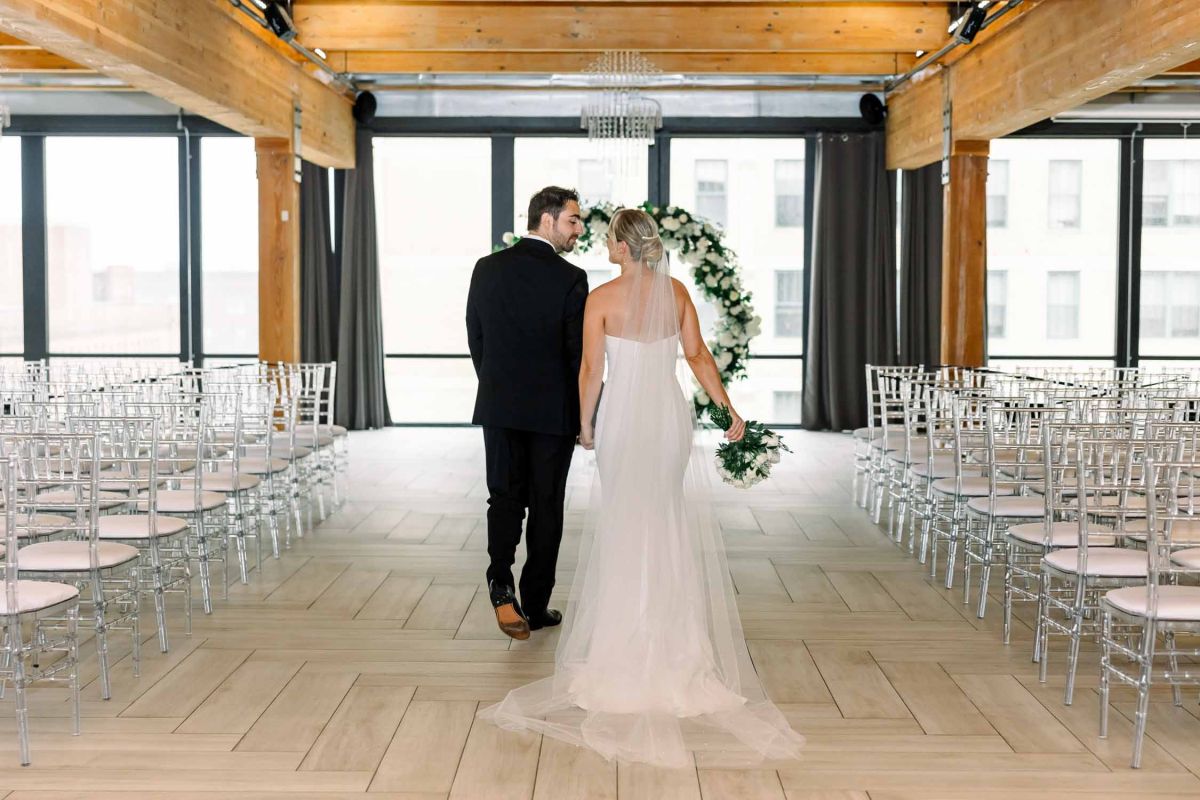 couple walking towards arbor